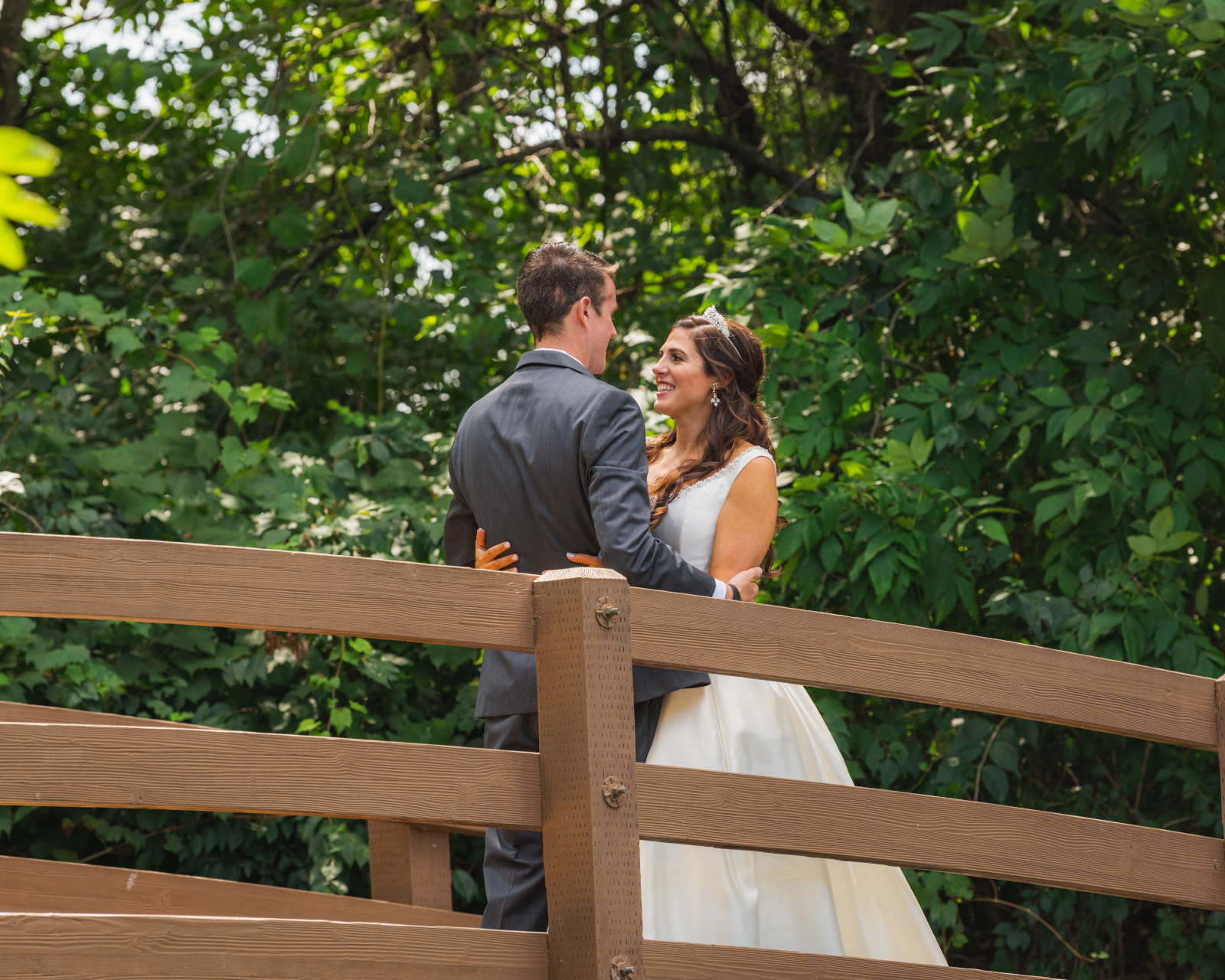 Bride and groom first look, smile, bridge, green, nature, trees, sweet wedding ceremony at Crocker Park, Westlake OH