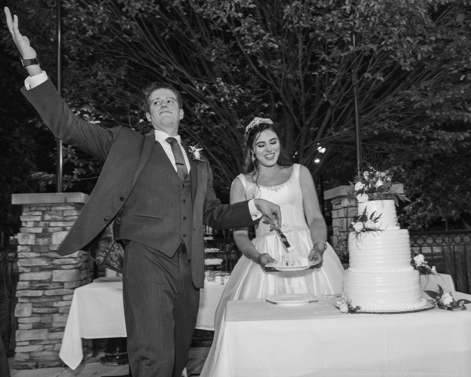 Bride and groom cutting the cake, cake cutting, fun wedding photo, smiling, laughing, black and white, sweet wedding reception at Crocker Park, Westlake OH