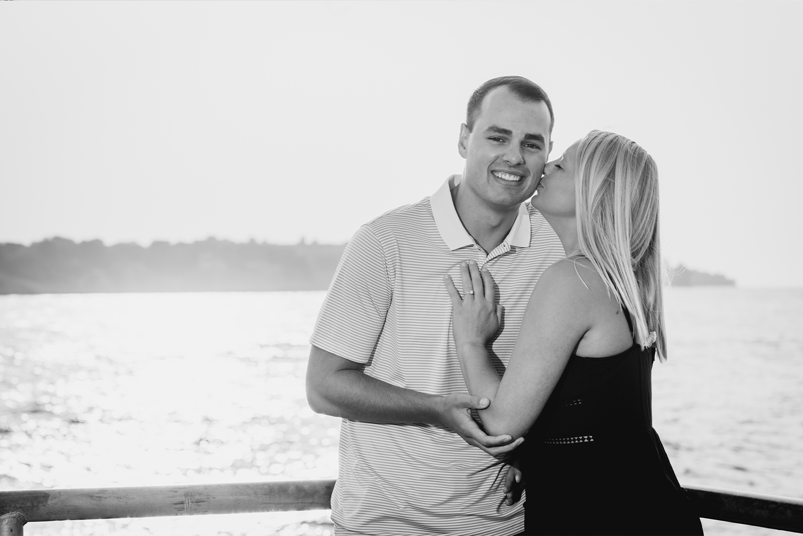 Man and woman fiancee engagement photo, couple portrait, kiss, smile, black and white, classic engagement portrait, nature, water, Lake Erie, Edgewater Beach, Cleveland Metroparks