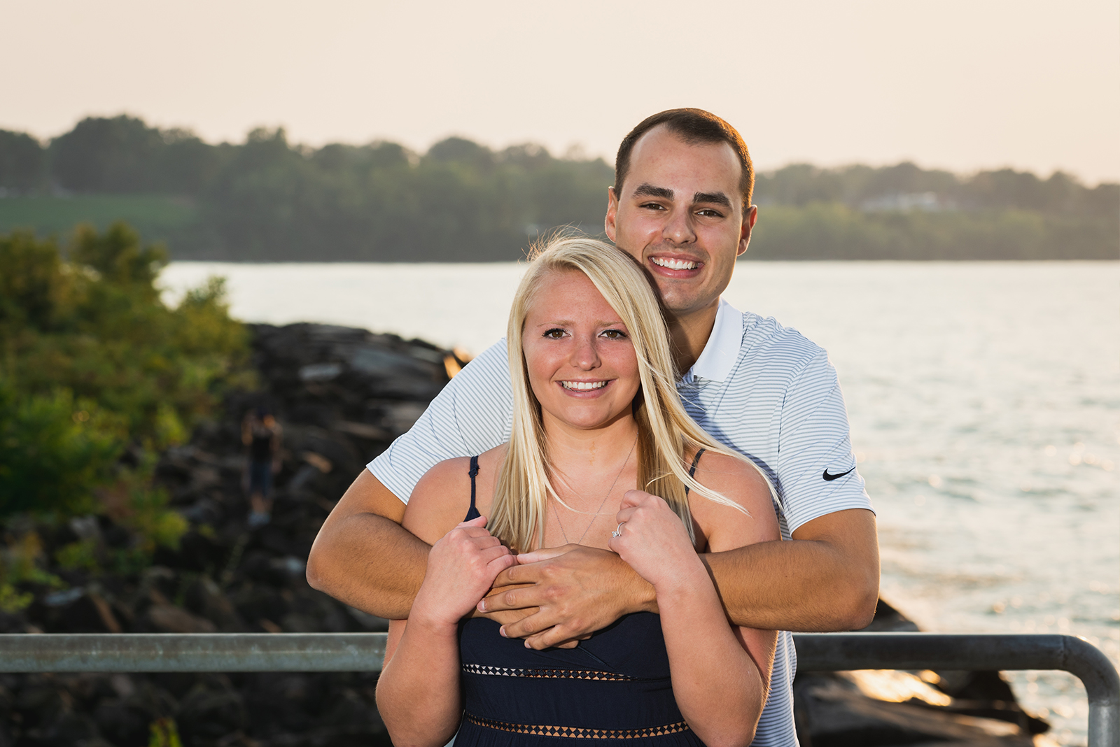 Man and woman fiancee engagement photo, couple portrait, smile, couple pose, water, trees, sunset, Lake Erie, Edgewater Beach, Cleveland Metroparks