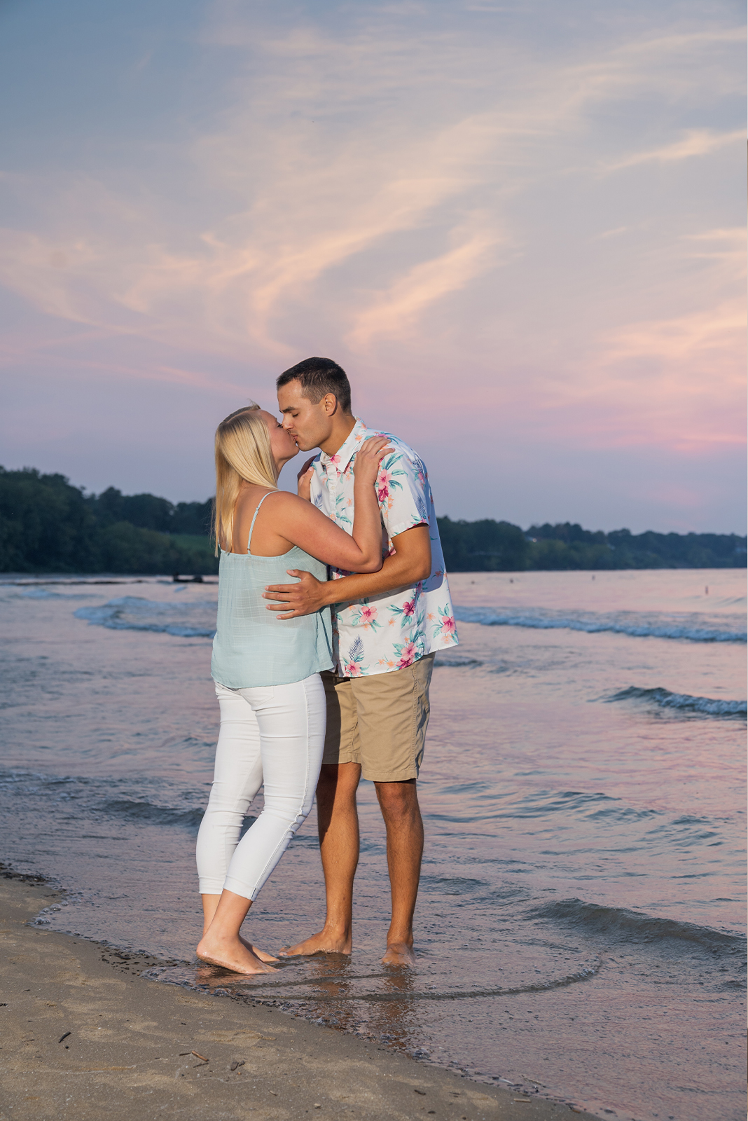 Man and woman fiancee engagement photo, couple portrait, kiss, beach, water, nature, trees, Lake Erie, sunset, Edgewater Beach, Cleveland Metroparks