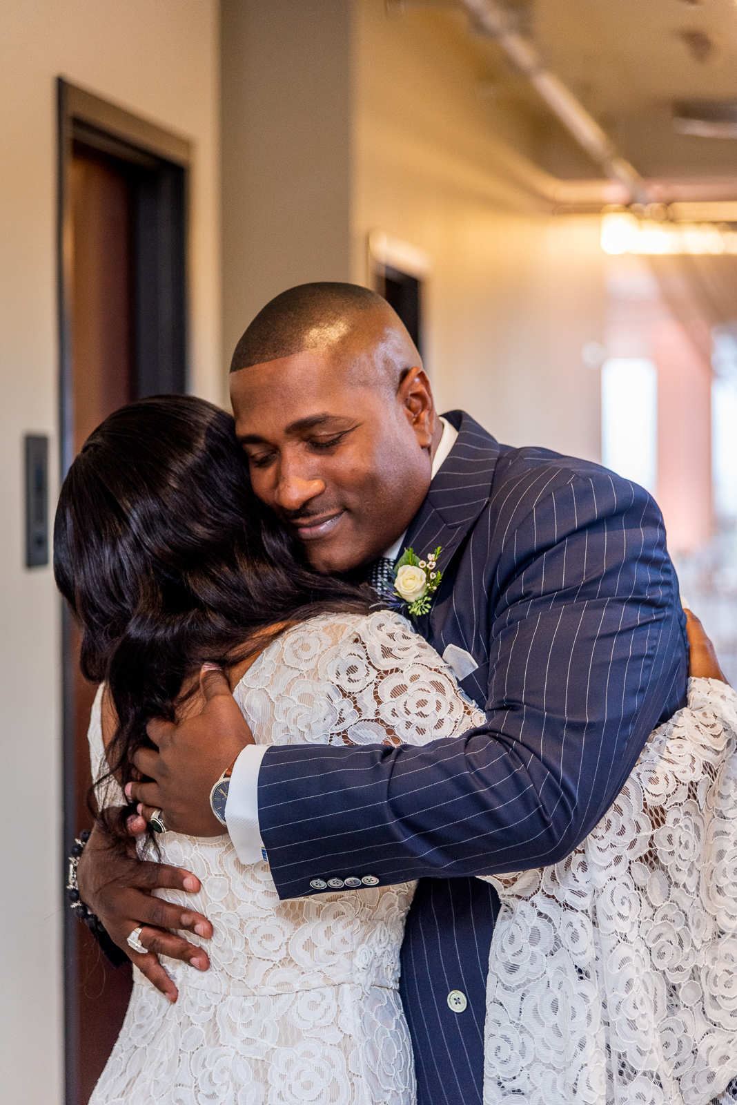 Bride with father, first look, hug, sweet, cute, pink light, pink uplighting, African American bride, African American wedding, urban wedding ceremony at Penthouse Events, Ohio City, Cleveland Flats