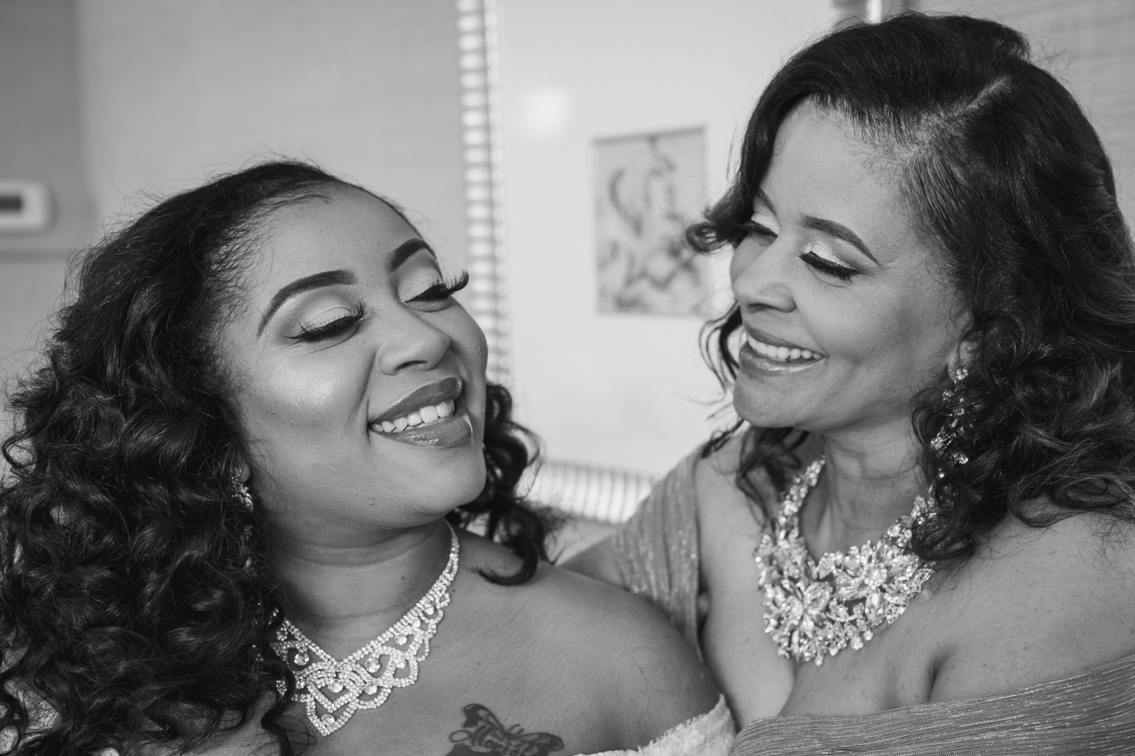 Bride with mom, getting ready, hair and makeup, jewelry, wedding preparation, smile, candid, beautiful, black and white, classic, African American bride, African American wedding, romantic wedding ceremony at Hilton Akron/Fairlawn