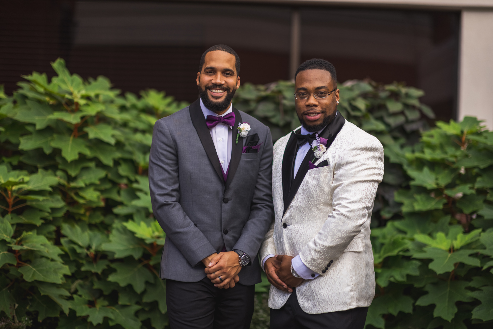 Groom with groomsman, bridal party portrait, green bushes, nature, African American groom, African American wedding, romantic wedding ceremony at Hilton Akron/Fairlawn