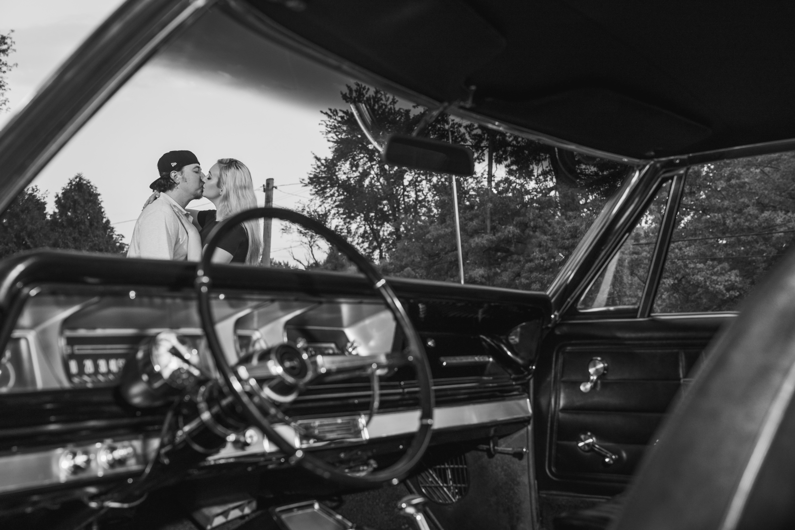 Man and woman fiancee engagement photo, couple portrait, vintage car, black and white, unique engagement photo, kiss, fall outdoor engagement photo shoot at Dairy King