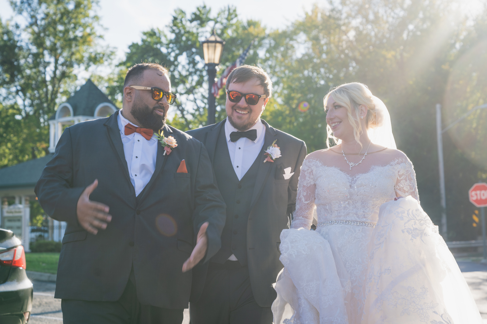 Bride and groom with groomsmen, walking, sunglasses, sunlight, lens flare, smiling, laughing, candid wedding photo, fall wedding, cute outdoor wedding ceremony at Grand Pacific Wedding Gardens