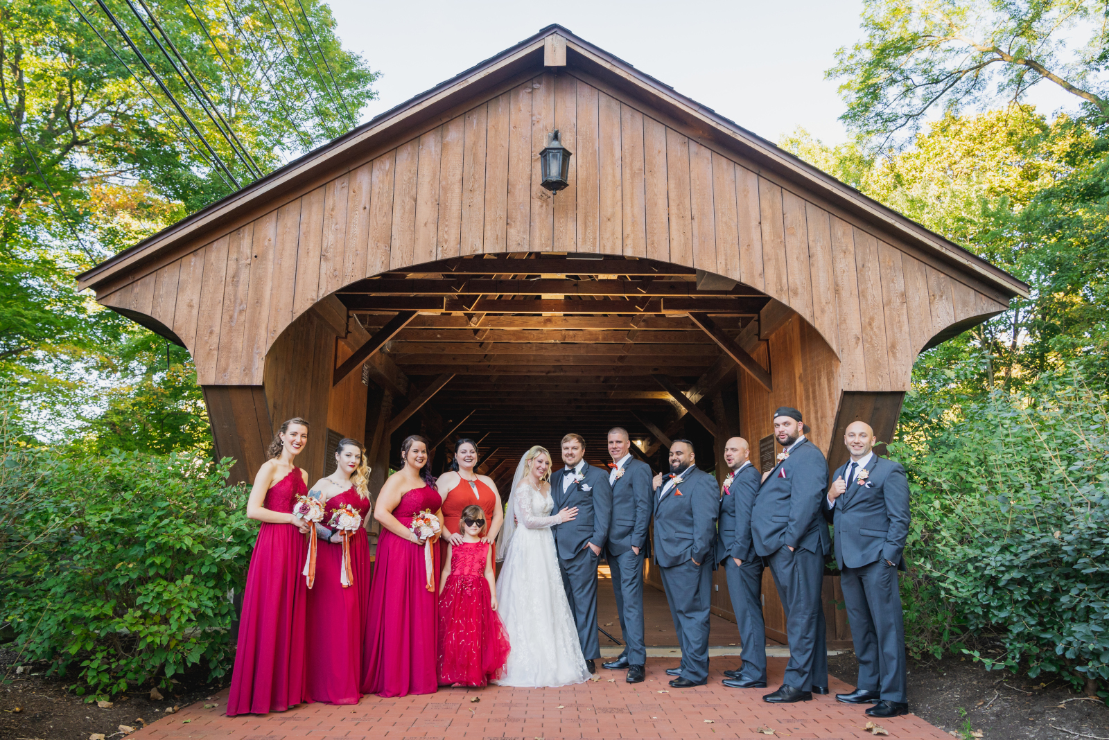Bride and groom with bridal party, bridal party portrait, covered bridge, nature, green, trees, fall wedding, cute outdoor wedding ceremony at Grand Pacific Wedding Gardens