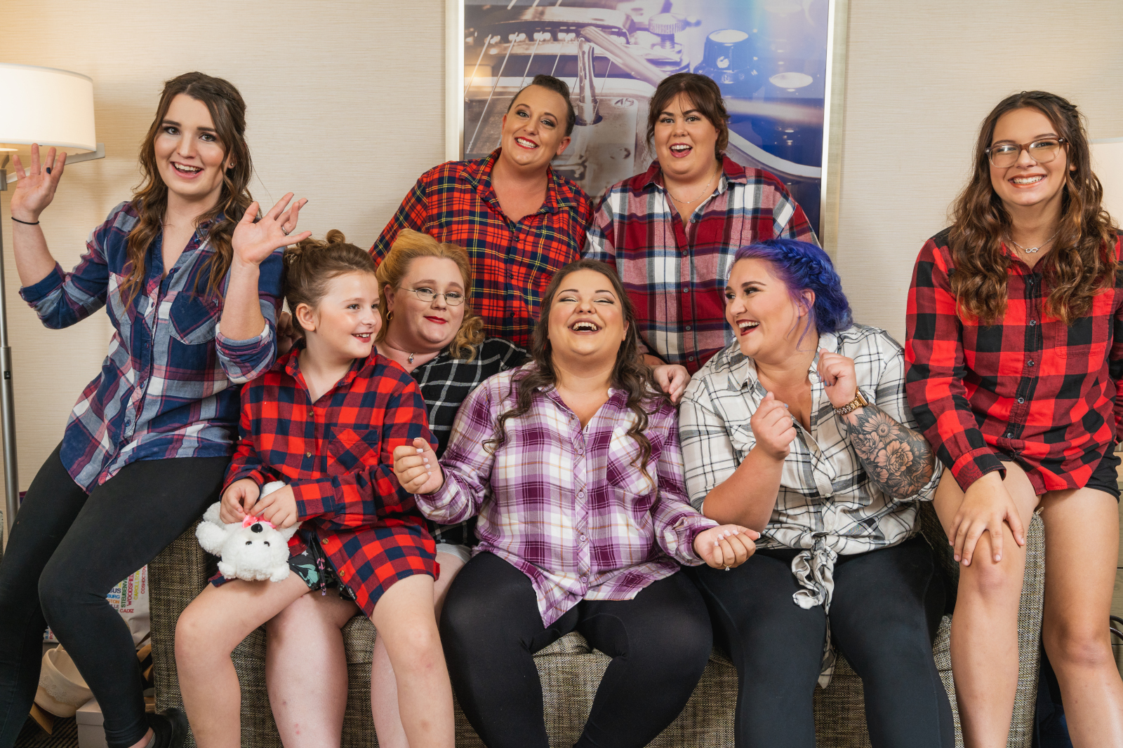 Bride with bridesmaids and flower girl getting ready, wedding preparation, bridal party portrait, fun bridal party portrait, laughing, matching flannel, outdoor September wedding ceremony at Westfall Event Center