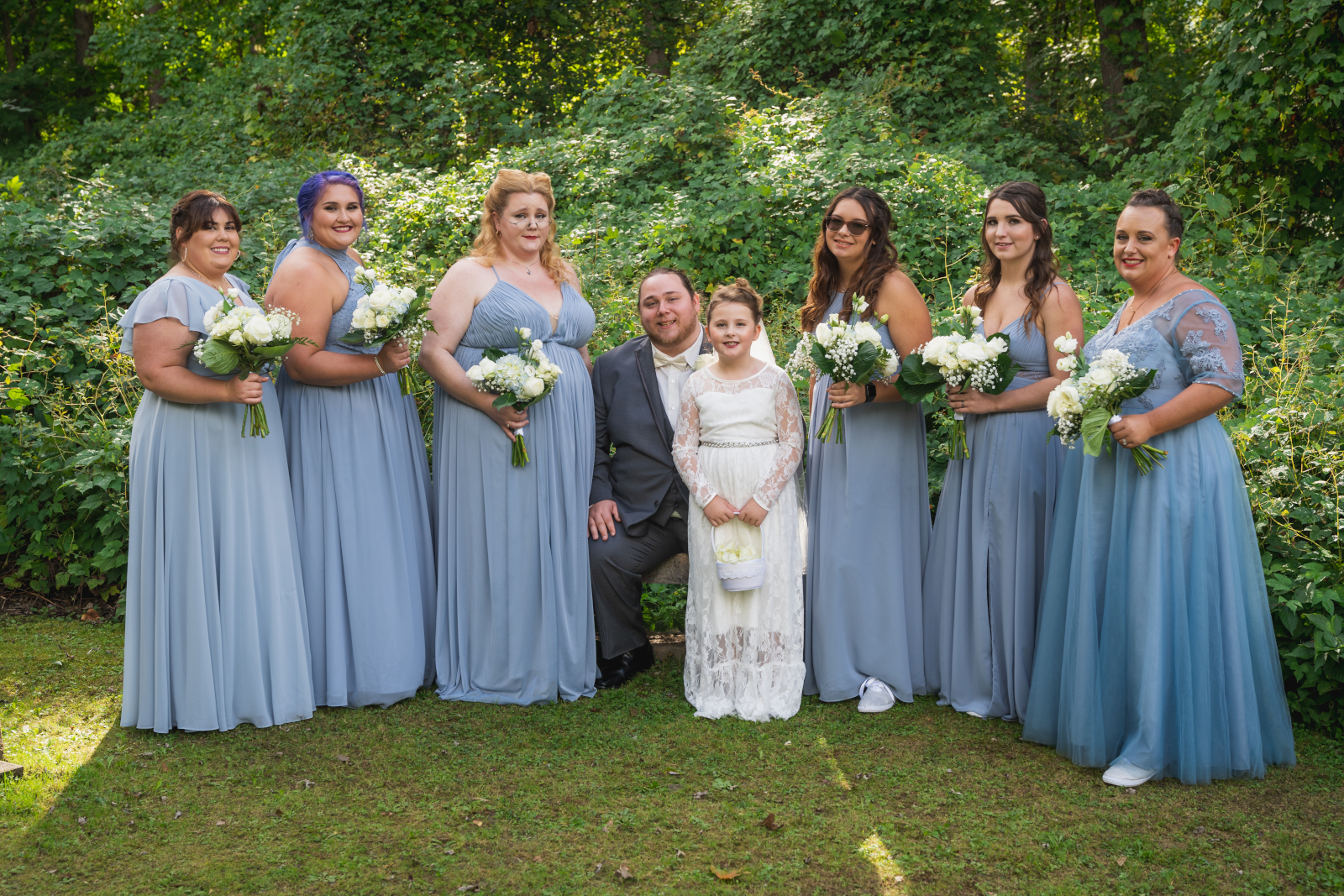 Groom with bridesmaids and flower girl, bridal party portrait, green, nature, trees, outdoor September wedding at Westfall Event Center
