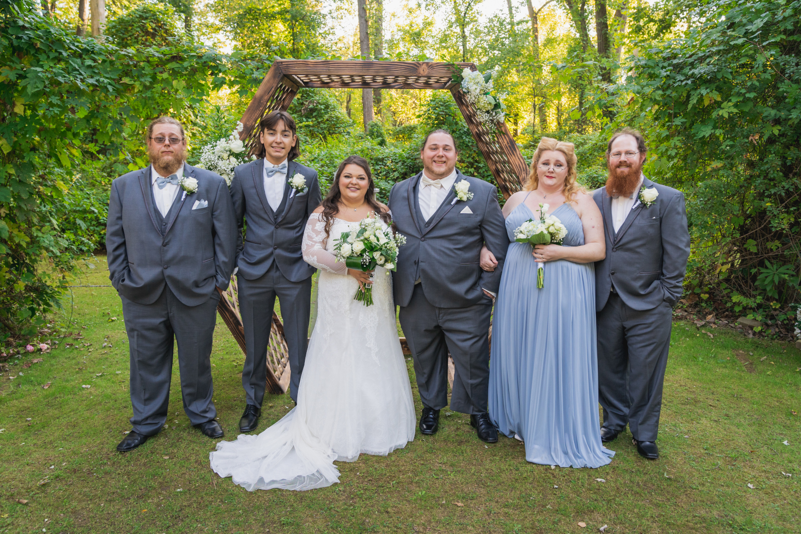 Bride and groom with bridal party, bridal party portrait, hexagon arch, green, nature, trees, outdoor September wedding ceremony at Westfall Event Center