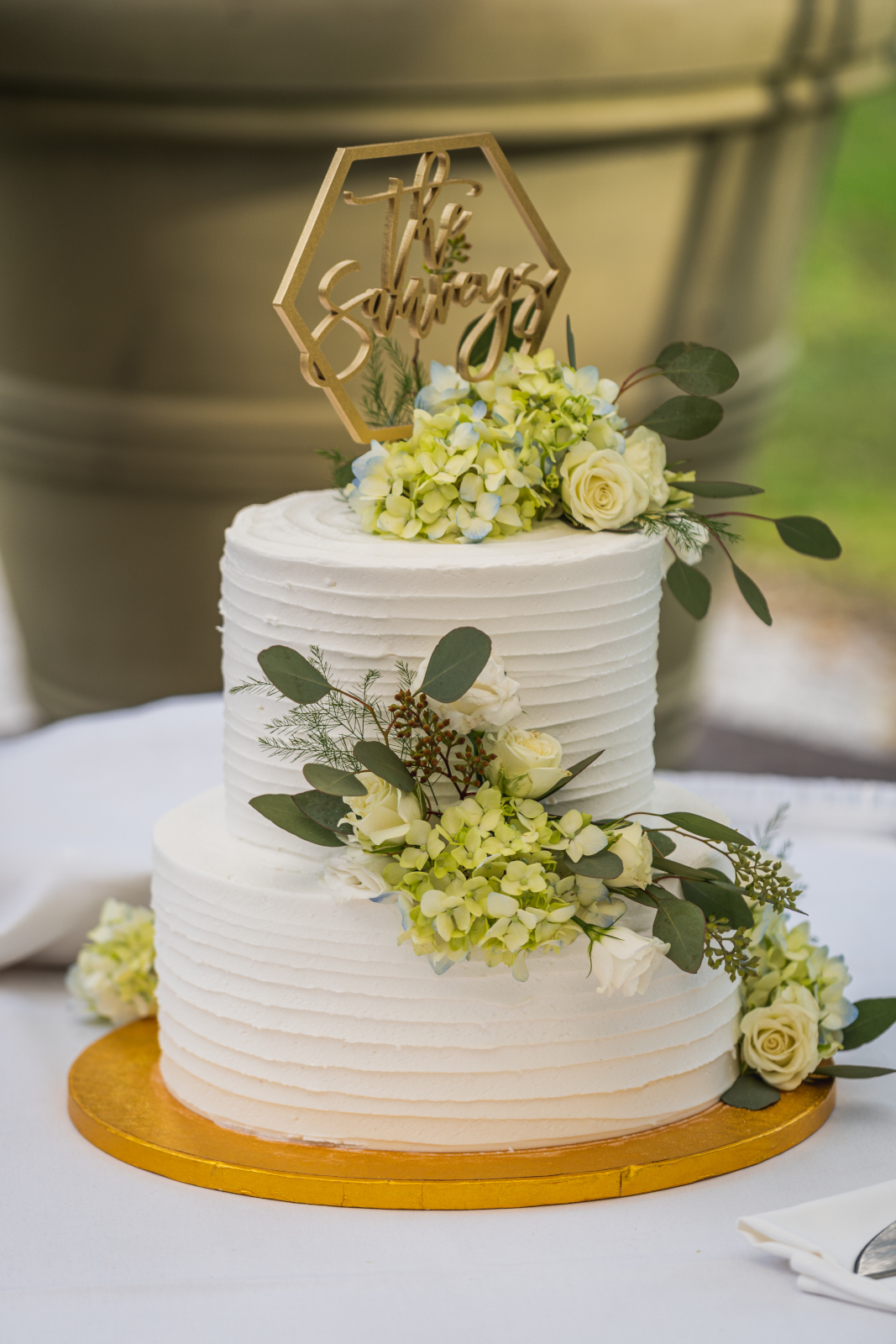 Wedding cake, cute wedding cake topper, green flowers, gold, outdoor wedding, September wedding reception at Westfall Event Center