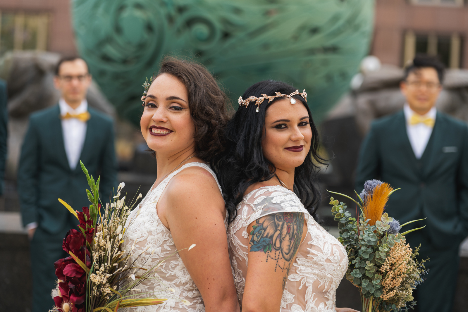 Two brides first look with bridal party, bridal party portrait, large bridal party, mixed bridal party, smile, sweet, romantic, urban, two wedding dresses, love is love, beautiful lesbian wedding at the House of Blues Cleveland, downtown Cleveland, Fountain of Eternal Youth