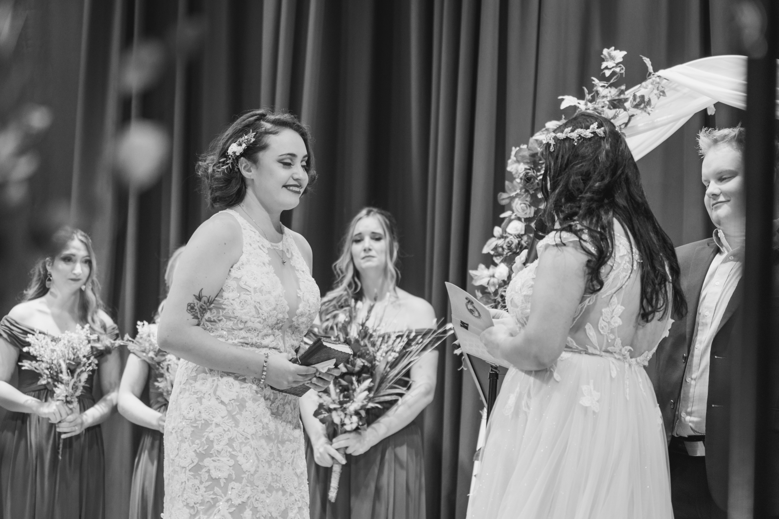 Two brides exchange vows at wedding ceremony, sweet, romantic, classic wedding photo, smile, black and white, two wedding dresses, love is love, beautiful lesbian wedding ceremony at House of Blues Cleveland