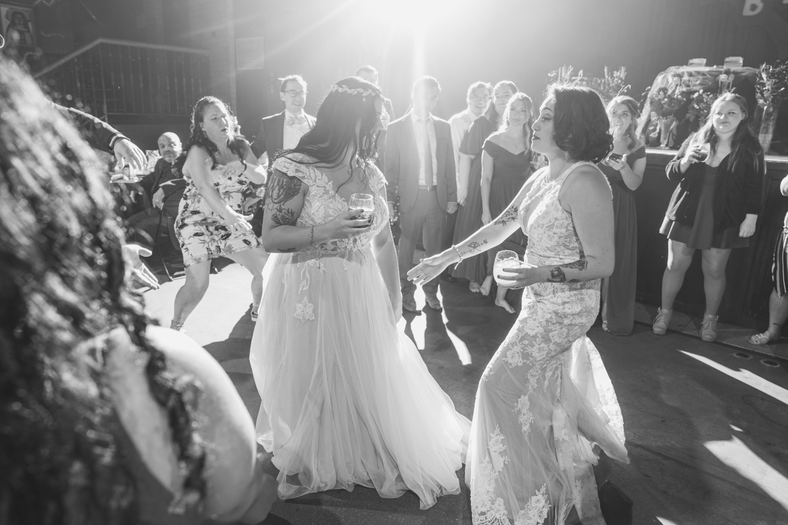 Two brides dance, fun, music, wedding DJ, Sound Precision Entertainment, two wedding dresses, love is love, candid, black and white, beautiful lesbian wedding reception at the House of Blues Cleveland