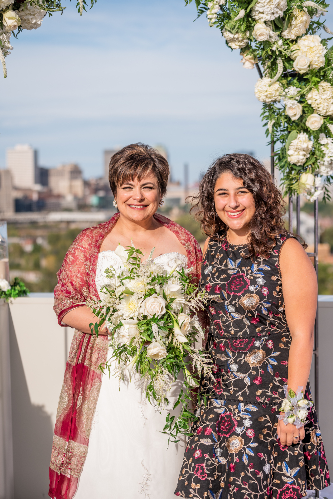 Bride with young girl, family portrait, older couple, romantic outdoor urban wedding ceremony at Penthouse Events, Ohio City, Cleveland Flats, downtown Cleveland skyline