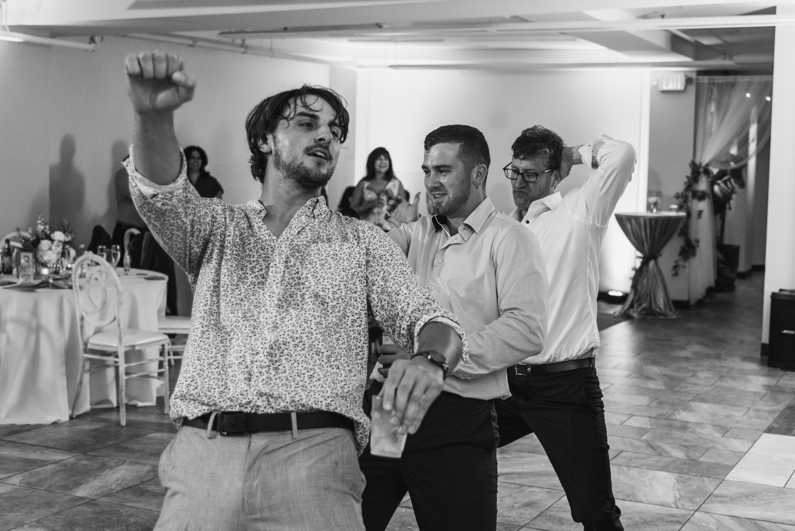 Groom dancing with friends, fun wedding photo, candid, black and white, music, wedding DJ, romantic urban wedding reception at Penthouse Events, Ohio City, Cleveland Flats