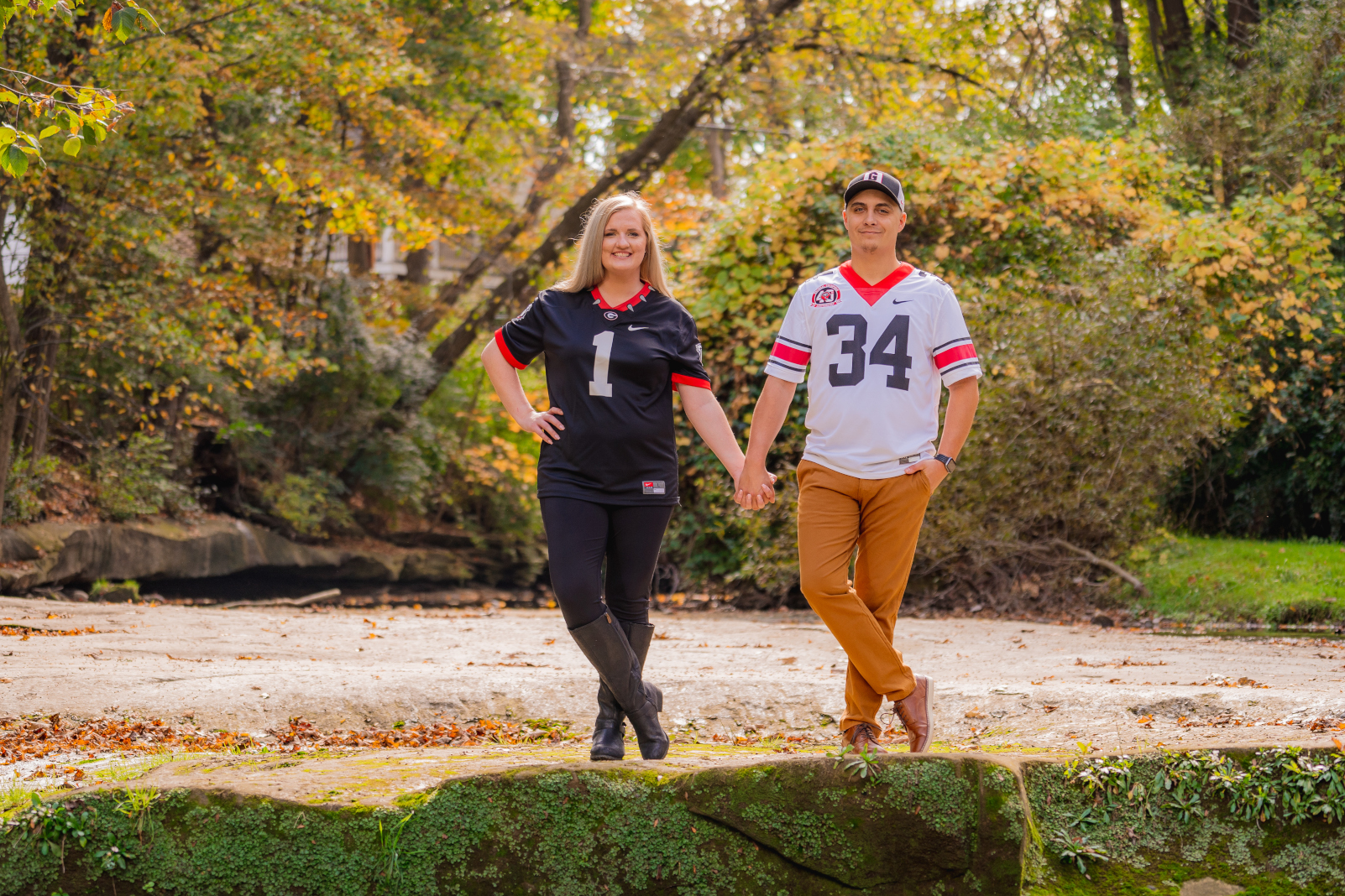Man and woman fiancee engagement photo, couple portrait, smile, holding hands, nature, fall leaves, fall colors, outdoor fall engagement photo session at Grand Pacific Junction Historic Shopping District
