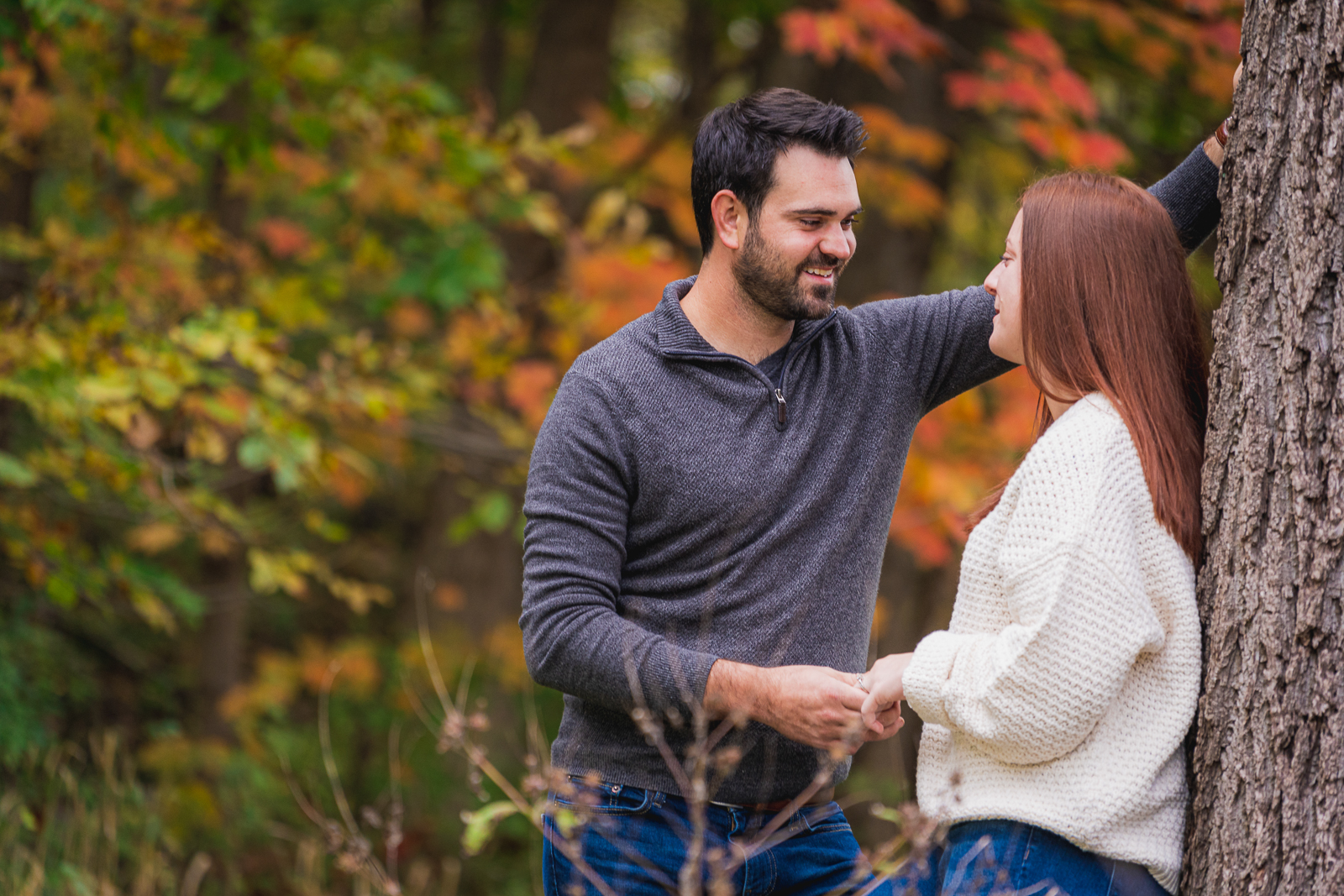Man and woman fiancee engagement photo, couple portrait, fall leaves, fall colors, cute, smile, nature, forest, trees, outdoor fall engagement photo session at Tinkers Creek, Bedford Reservation, Cleveland Metroparks