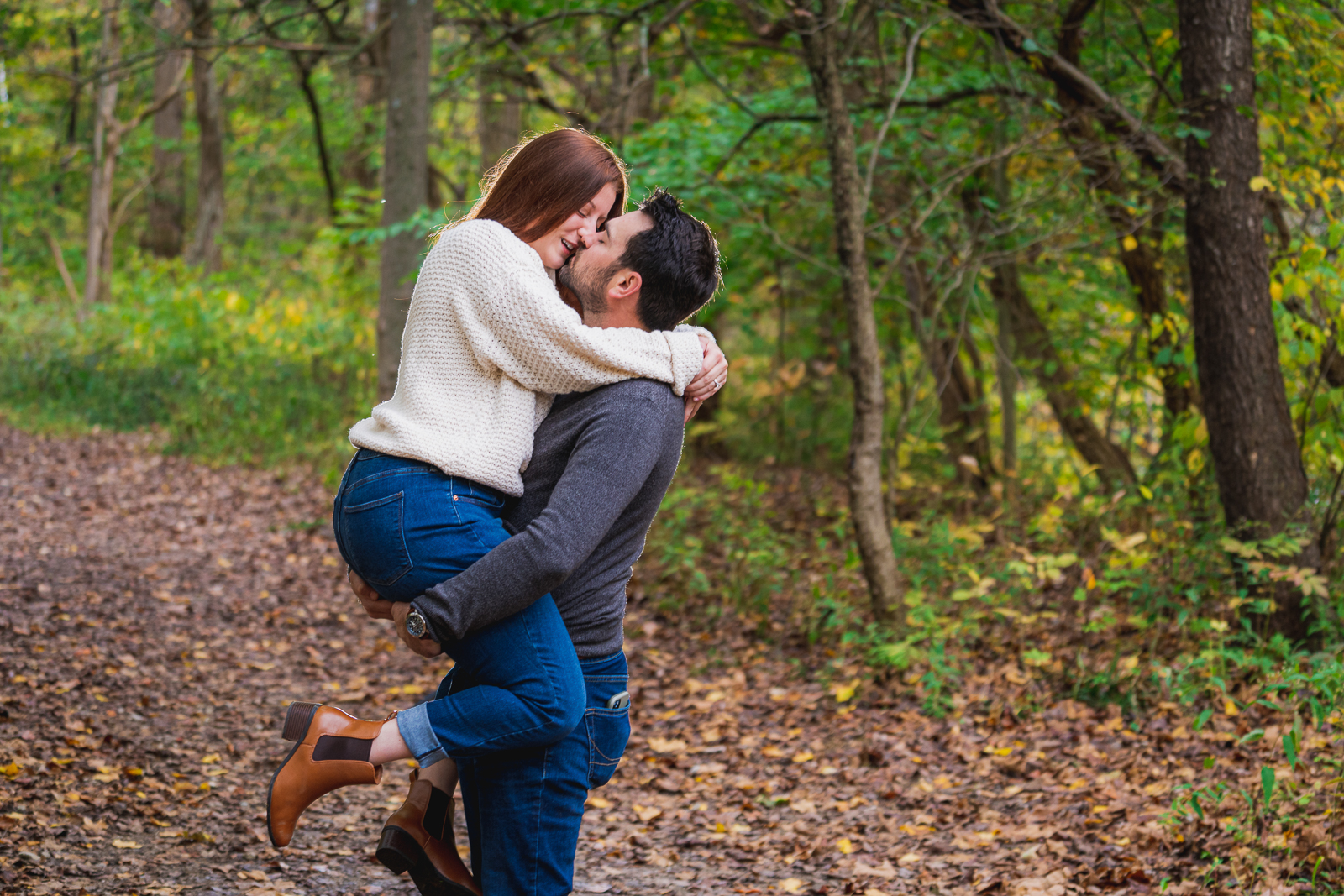 Man and woman fiancee engagement photo, couple portrait, fall leaves, fall colors, cute, kiss, nature, forest, trees, outdoor fall engagement photo session at Tinkers Creek, Bedford Reservation, Cleveland Metroparks