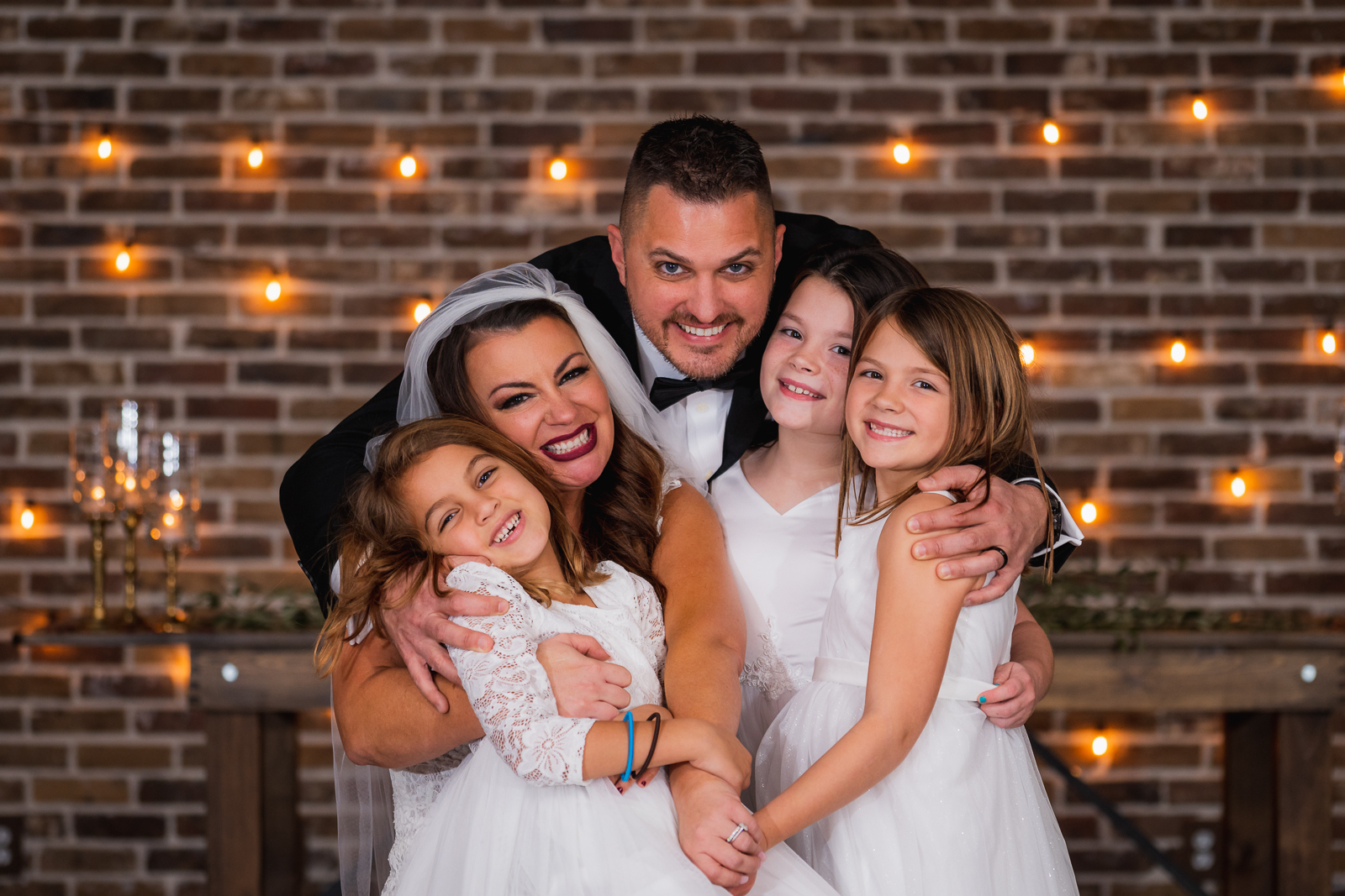 Bride and groom with daughters, flower girls, family portrait, wedding portrait, wedding reception at Gather at the Lakes