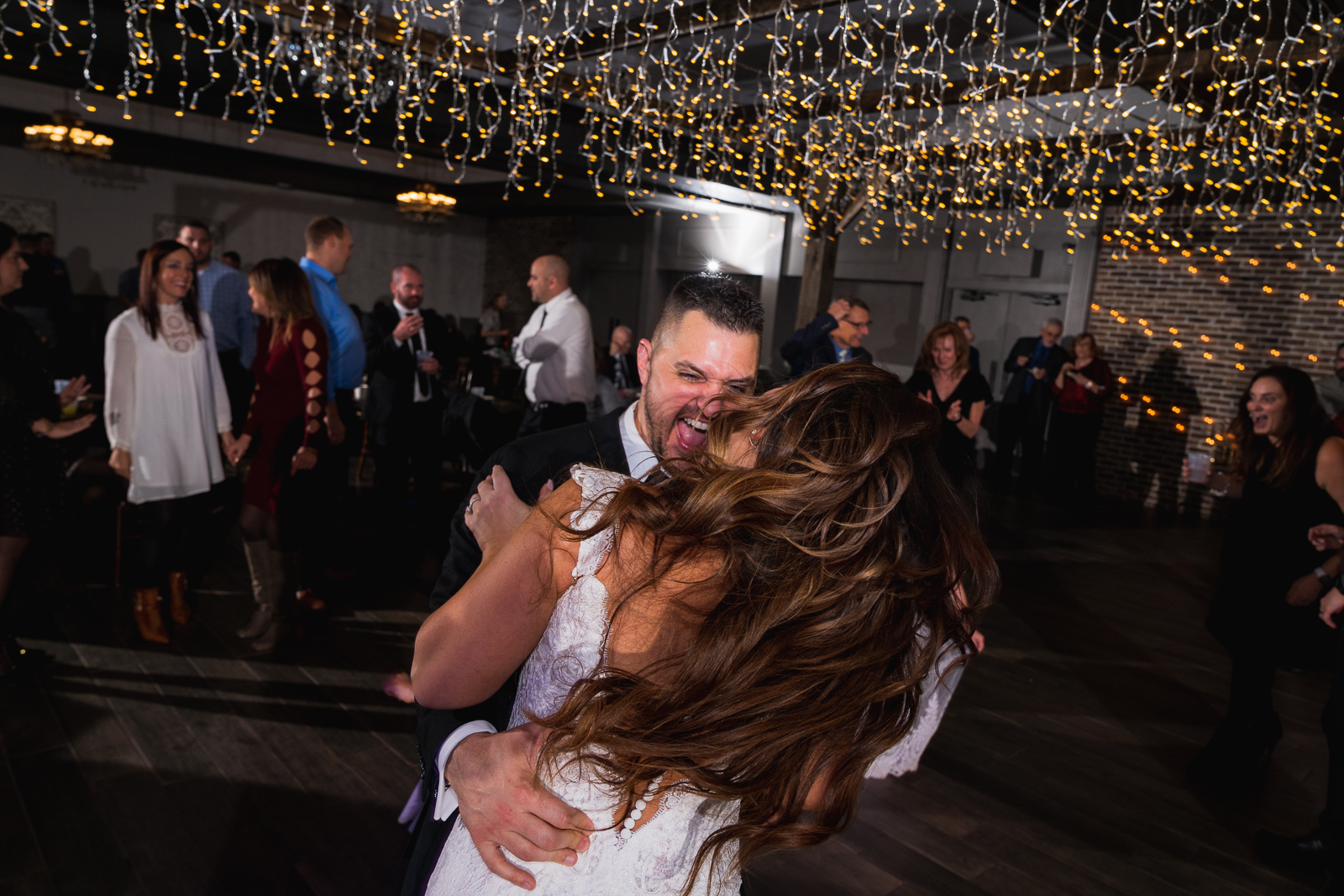 Bride and groom, laughing, dancing, wedding candid, wedding reception at Gather at the Lakes
