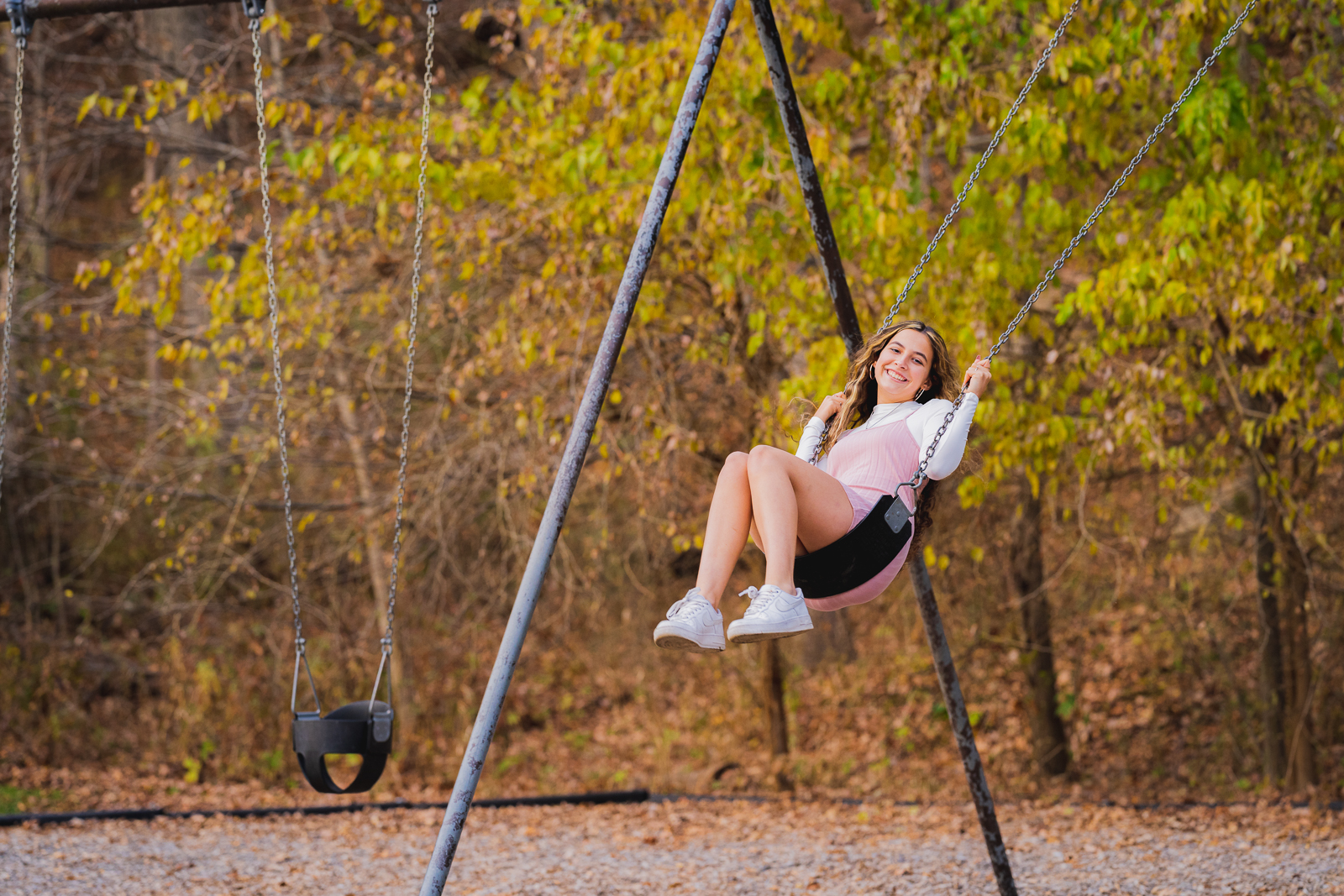 High school girl senior pictures, fall, swing set, outdoor photo session at Tinkers Creek