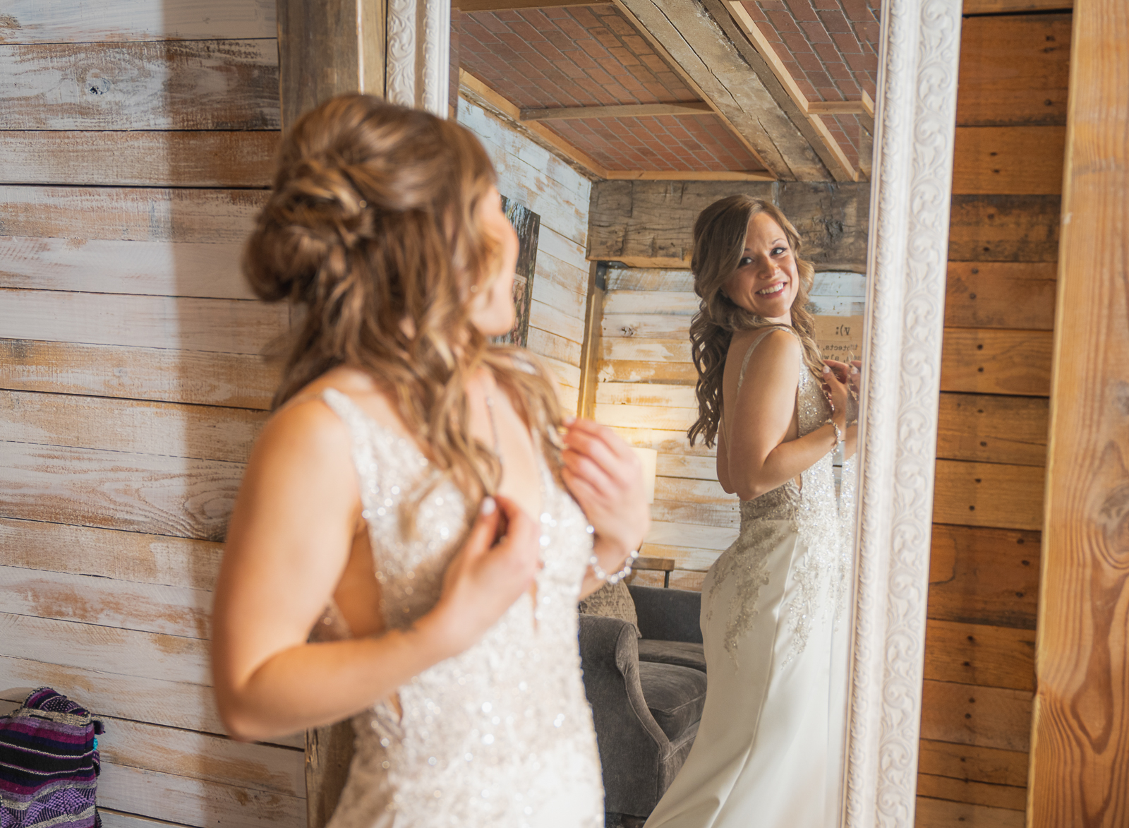Bride getting ready, wedding preparation, wedding dress, mirror, smile, fall wedding, rustic outdoor wedding ceremony at White Birch Barn
