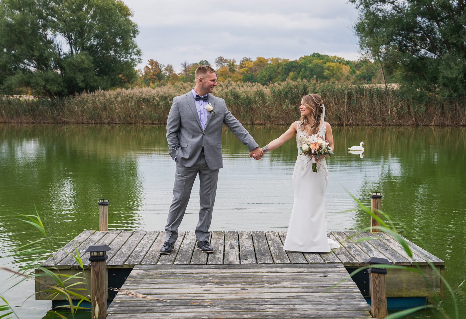 Bride and groom wedding portrait, dock, pond, duck, goose, nature, fall wedding, rustic outdoor wedding ceremony at White Birch Barn