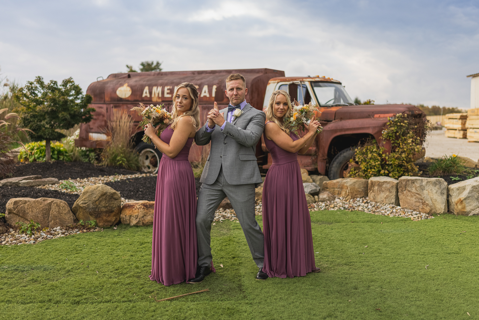 Groom with bridesmaids, bridal party portrait, fun bridal party portrait, old truck, American oil, fall wedding, outdoor rustic wedding ceremony at White Birch Barn