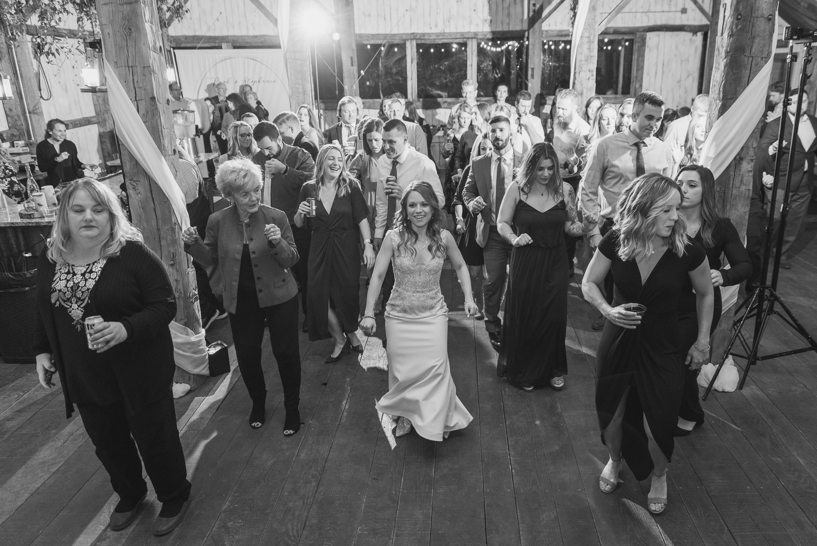 Bride, dance, line dance, music, DJ, fun, rustic wedding reception at White Birch Barn